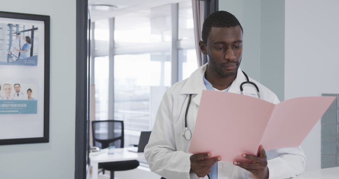 Confident Doctor Reviewing Patient Folder in Modern Clinic - Free Images, Stock Photos and Pictures on Pikwizard.com