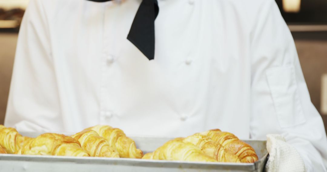 Pastry Chef Holding Tray of Freshly Baked Croissants - Free Images, Stock Photos and Pictures on Pikwizard.com