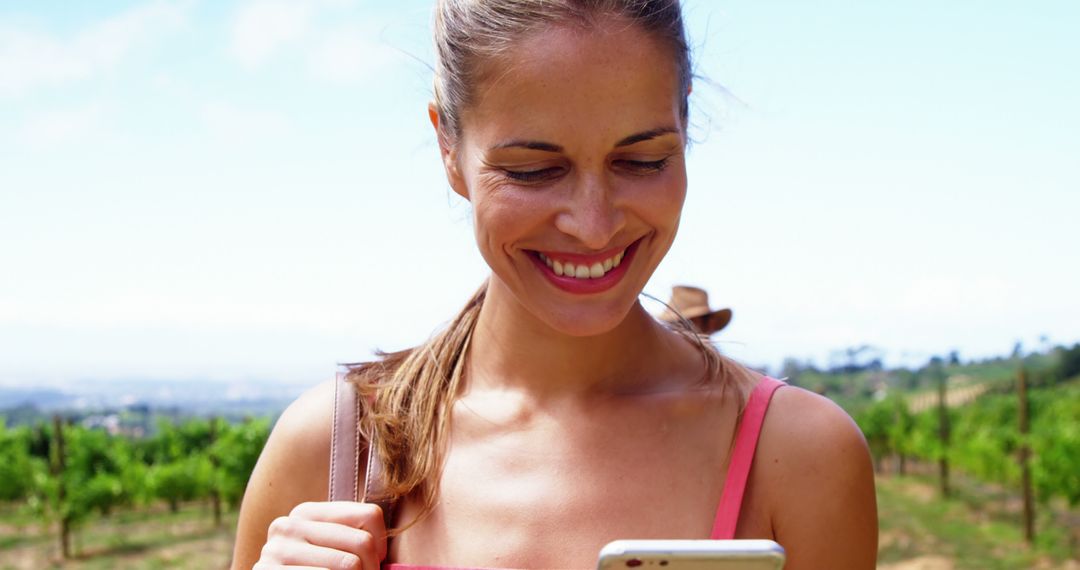 Smiling Woman Using Smartphone in Vineyards - Free Images, Stock Photos and Pictures on Pikwizard.com