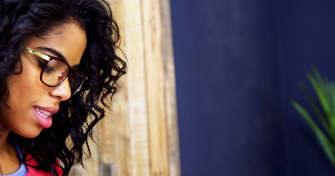 Focused Woman with Glasses Reading in Cafe
