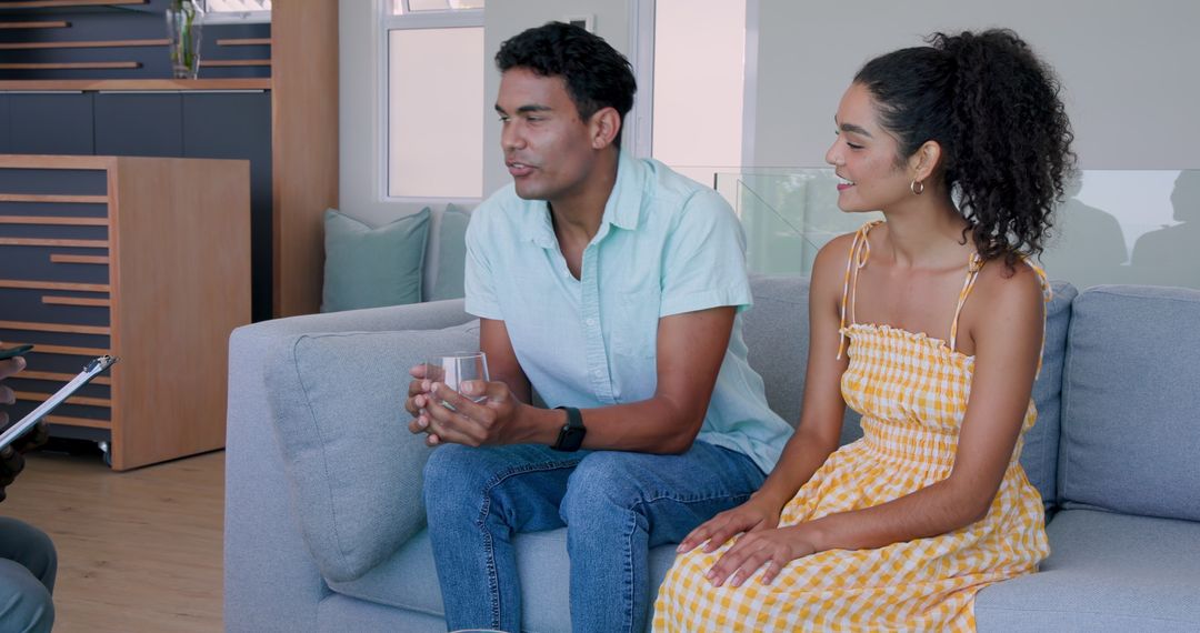 Young Couple Engaged in Counseling Session on Couch