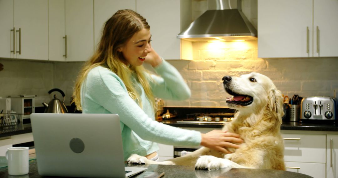 Young Woman Petting Golden Retriever in Modern Kitchen - Free Images, Stock Photos and Pictures on Pikwizard.com