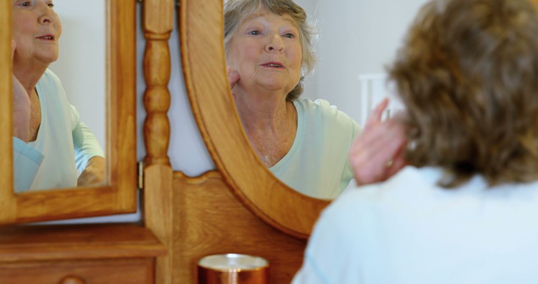 Senior Woman Applying Skincare While Looking in Mirror - Free Images, Stock Photos and Pictures on Pikwizard.com