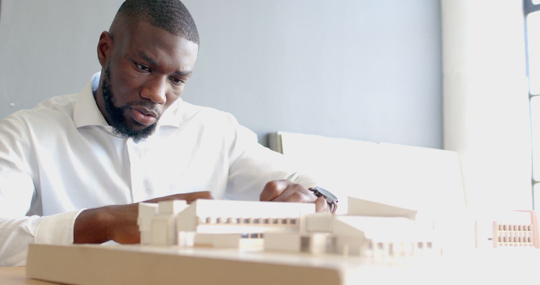 Architect Focusing on Detailed Building Model Design