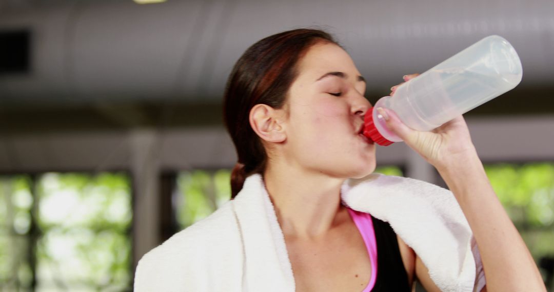Woman Hydrating After Workout in Gym - Free Images, Stock Photos and Pictures on Pikwizard.com