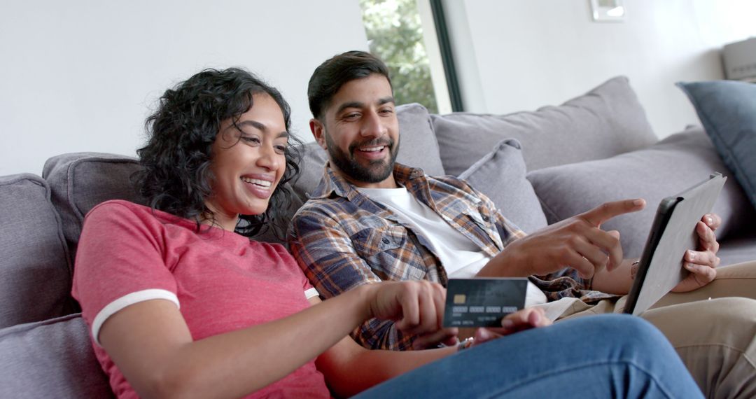 Smiling Couple Shopping Online Together with Tablet at Home