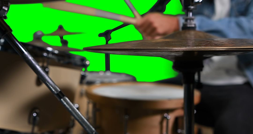 Mid section of drummer playing drum against green screen - Free Images, Stock Photos and Pictures on Pikwizard.com