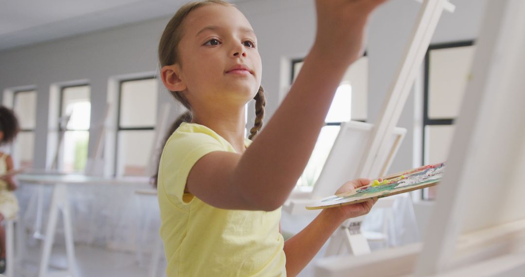 Young Girl Painting in Art Class Studio with Focused Expression - Free Images, Stock Photos and Pictures on Pikwizard.com