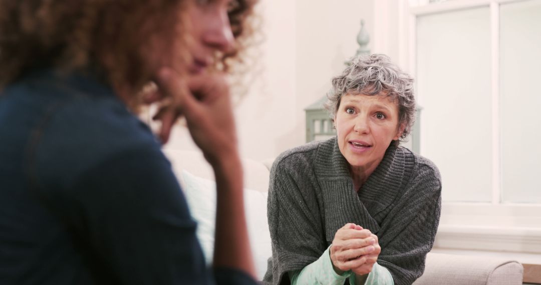 Elderly woman offering advice and support to younger woman - Free Images, Stock Photos and Pictures on Pikwizard.com