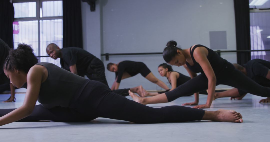 Diverse Dance Group Practicing Splits in Studio