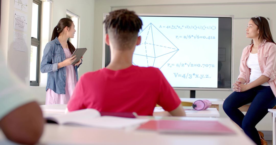 Asian student presenting STEM geometry lesson with tablet and digital display in classroom