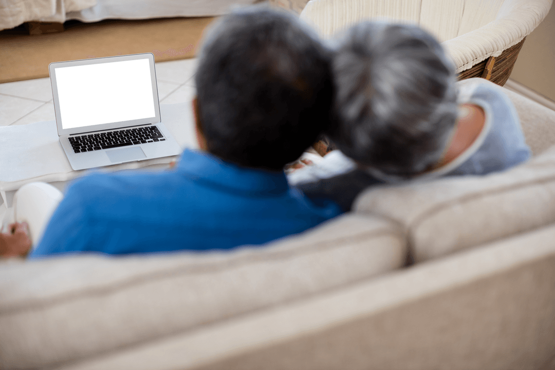 Senior Couple Relaxing on Sofa with Transparent Laptop Screen in Home