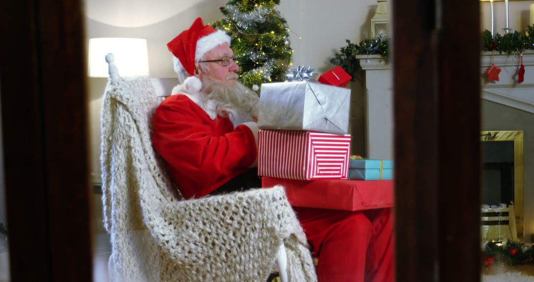 Santa Claus Unboxing Christmas Gifts Near Festive Fireplace - Free Images, Stock Photos and Pictures on Pikwizard.com