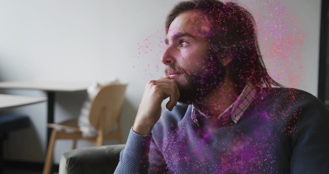 Contemplative Man With Dynamic Particle Effects in Creative Space