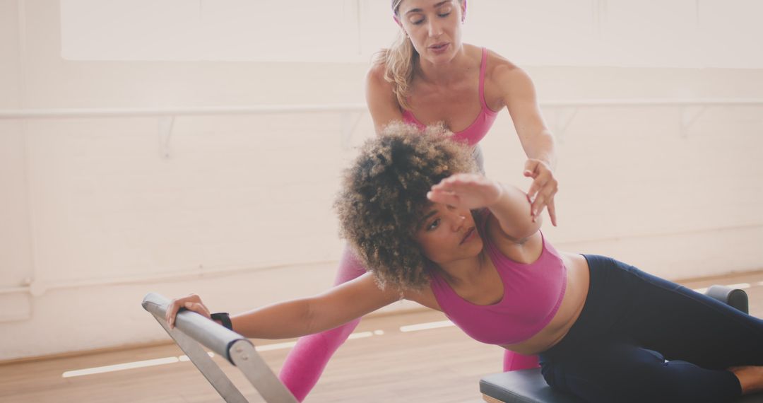 Women Engaging in Pilates Reformer Training Guided by Instructor