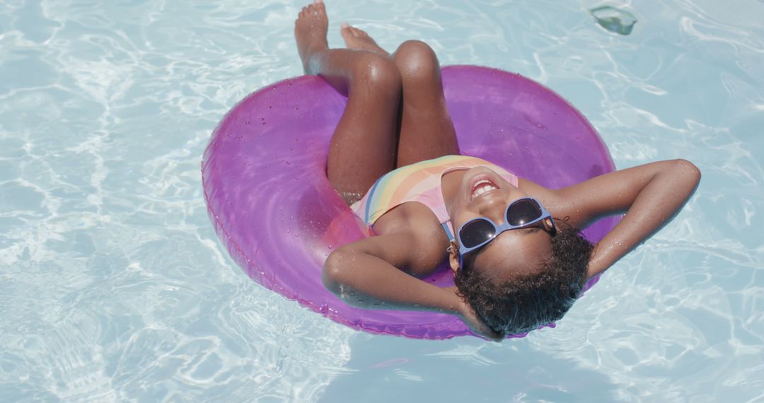 Happy Child Relaxing on Pool Float on Sunny Day - Free Images, Stock Photos and Pictures on Pikwizard.com