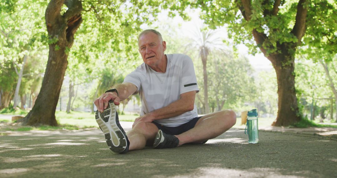 Senior Man Stretching Outdoors in a Sunny Park - Free Images, Stock Photos and Pictures on Pikwizard.com