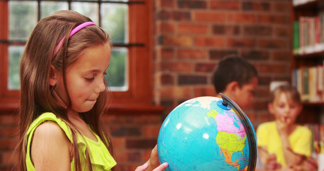 Young Girl Exploring Globe in Classroom - Free Images, Stock Photos and Pictures on Pikwizard.com