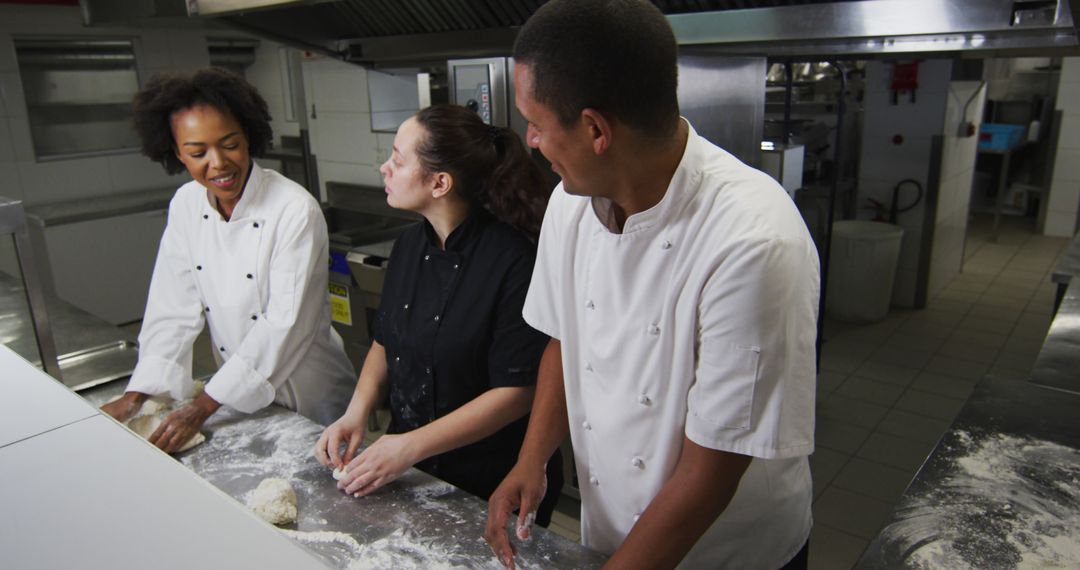 Chefs Talking and Preparing Dough in Busy Restaurant Kitchen