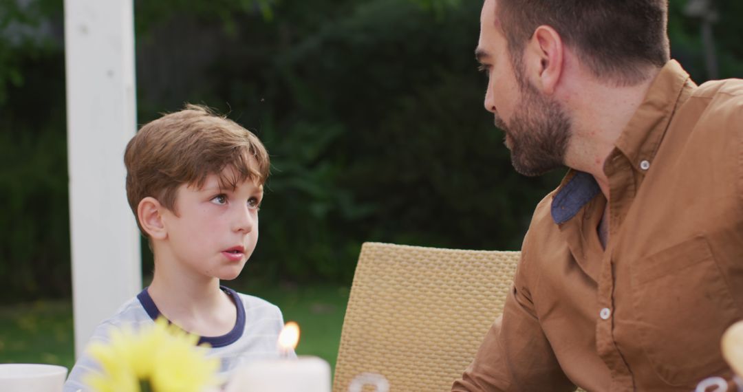 Father and Son Having Serious Conversation in Garden - Free Images, Stock Photos and Pictures on Pikwizard.com