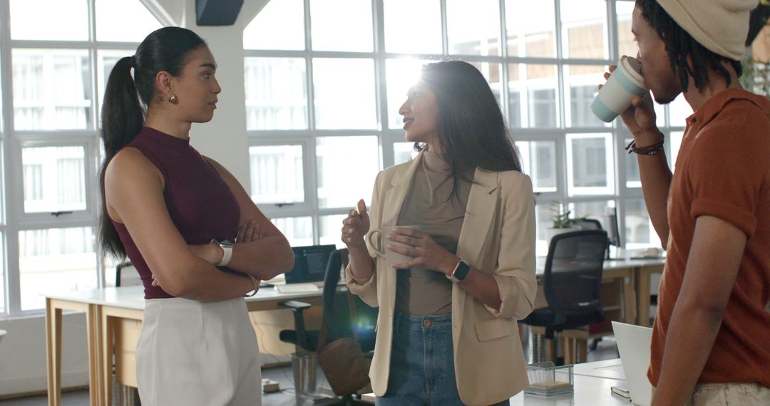 Collaborating in Sunlit Open-Plan Office: Diverse Coworkers Chatting Over Coffee