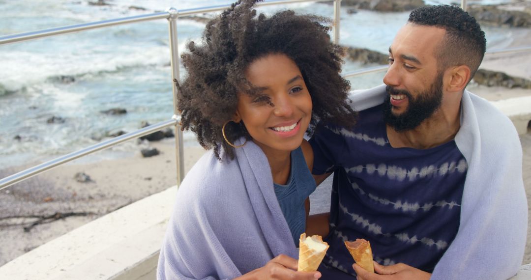 Happy couple enjoying ice cream by the ocean - Free Images, Stock Photos and Pictures on Pikwizard.com