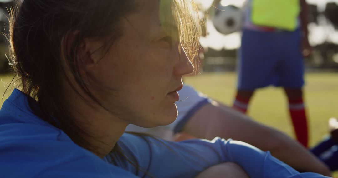 Young Woman Reflecting After Soccer Game on Sunny Day - Free Images, Stock Photos and Pictures on Pikwizard.com