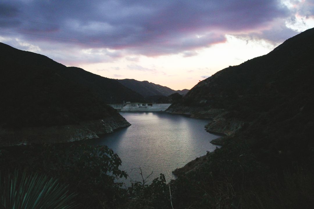 Serene Mountain Lake at Sunset with Purplish Clouds - Free Images, Stock Photos and Pictures on Pikwizard.com