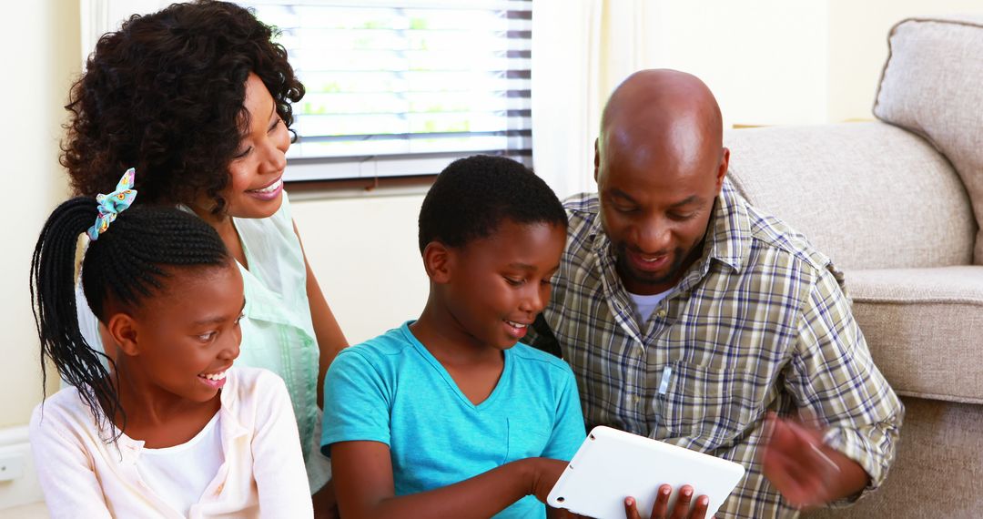 Happy African American Family Bonding While Using Tablet at Home - Free Images, Stock Photos and Pictures on Pikwizard.com