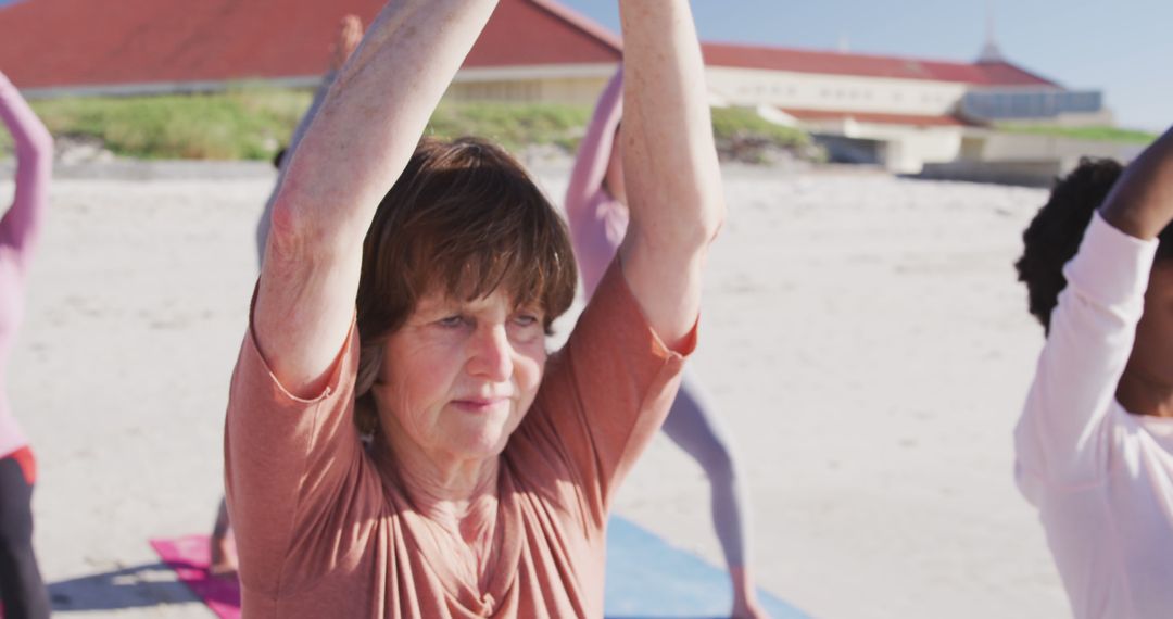 Senior Woman Doing Yoga on Beach with Group - Free Images, Stock Photos and Pictures on Pikwizard.com