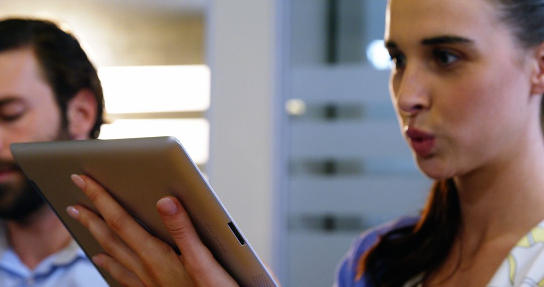 Woman Using Tablet in Modern Office Setting - Free Images, Stock Photos and Pictures on Pikwizard.com