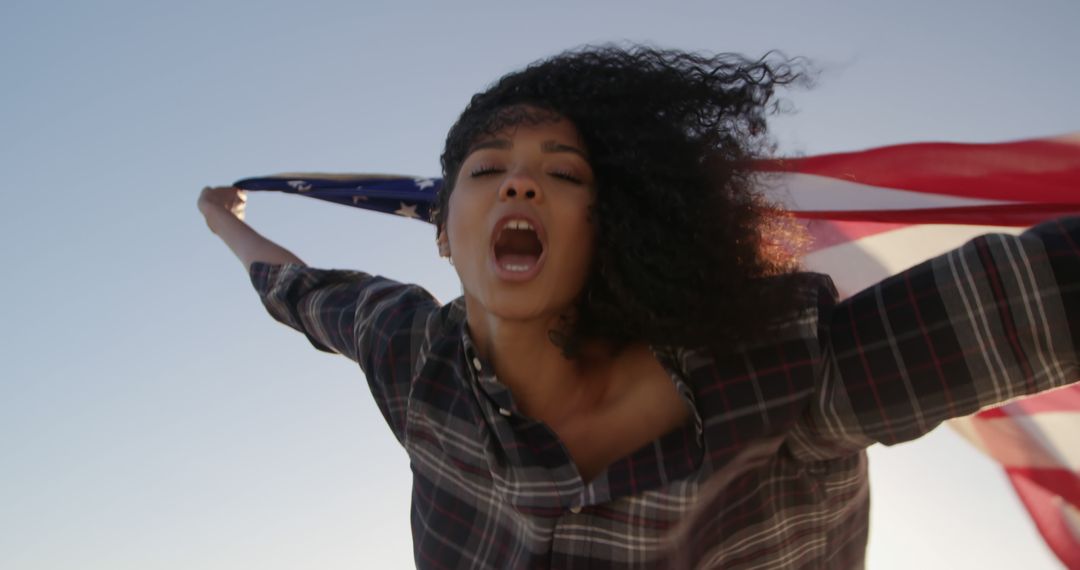 Joyful Woman Holding American Flag Outdoors During Sunset - Free Images, Stock Photos and Pictures on Pikwizard.com