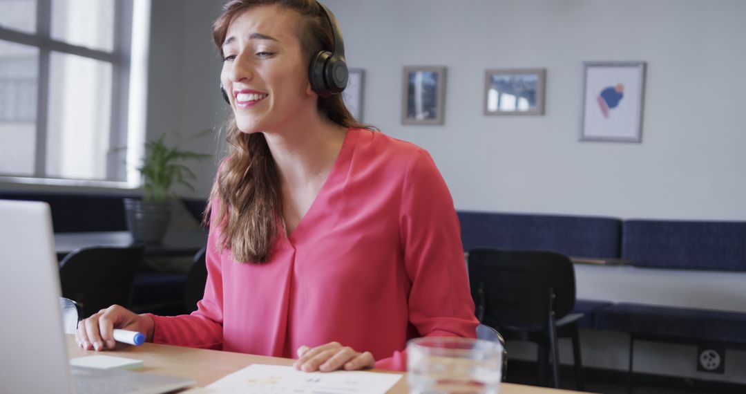 Smiling Businesswoman Wearing Headphones in Virtual Meeting - Free Images, Stock Photos and Pictures on Pikwizard.com