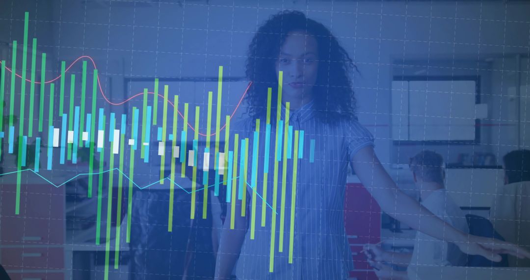 Presenter pointing at interactive data dashboard with teal charts in open-plan office