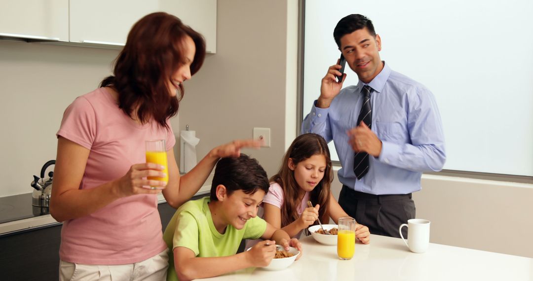 Busy Family Having Breakfast at Home Before Work and School - Free Images, Stock Photos and Pictures on Pikwizard.com