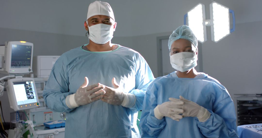 Portrait of diverse surgeons with face masks and medical gloves in operating room - Free Images, Stock Photos and Pictures on Pikwizard.com