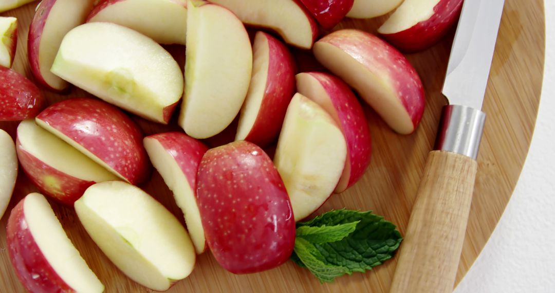 Freshly Cut Red Apple Slices on Wooden Chopping Board