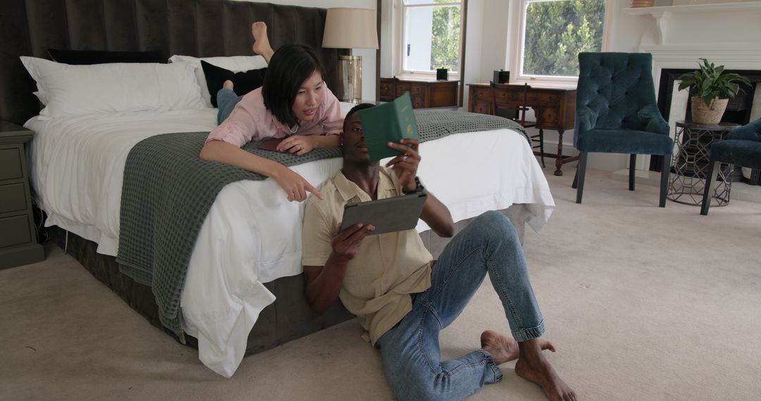 Couple Relaxing in Bedroom Sharing Tablet Experience