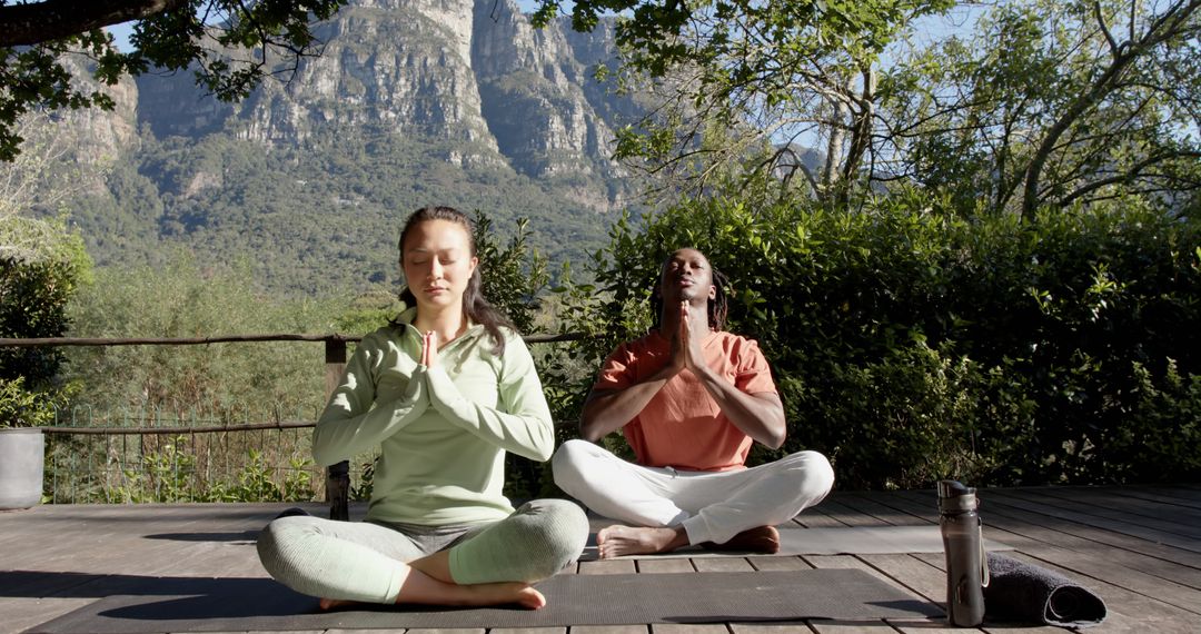 Two People Meditating Outdoors in Scenic Mountain Setting - Free Images, Stock Photos and Pictures on Pikwizard.com