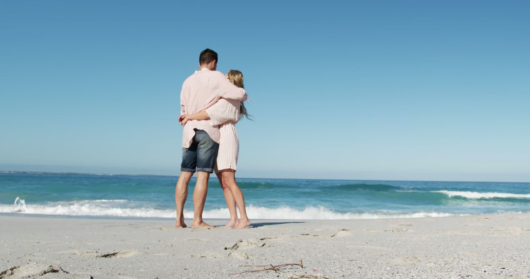 Couple Embracing on Beach During Sunny Day - Free Images, Stock Photos and Pictures on Pikwizard.com