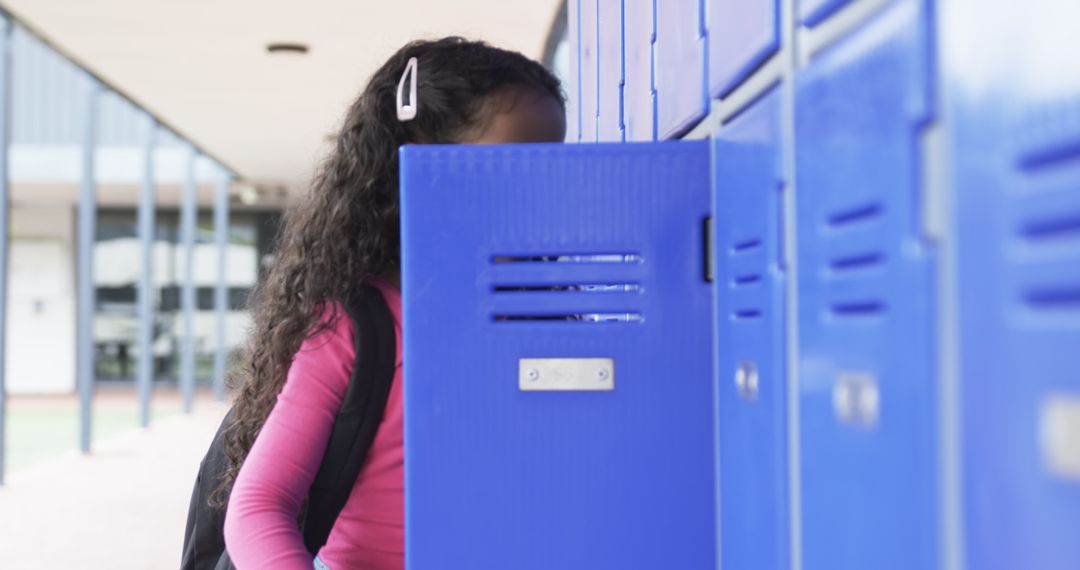 Student Exploring School Locker with Concentration