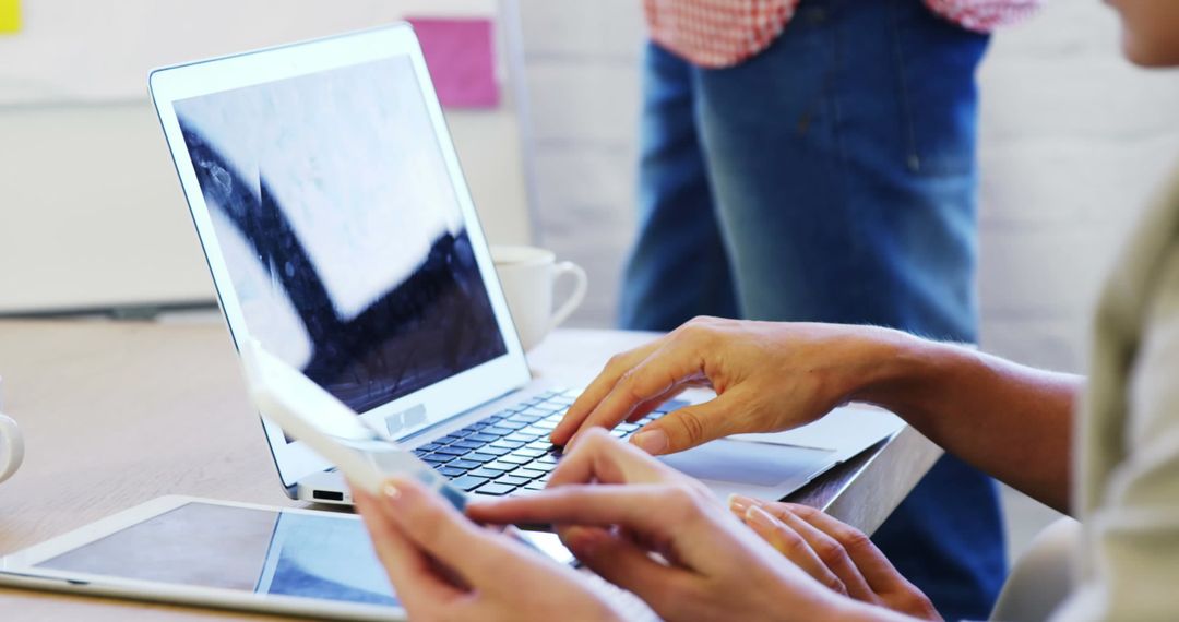 Team Collaboration with Laptop in Office Environment