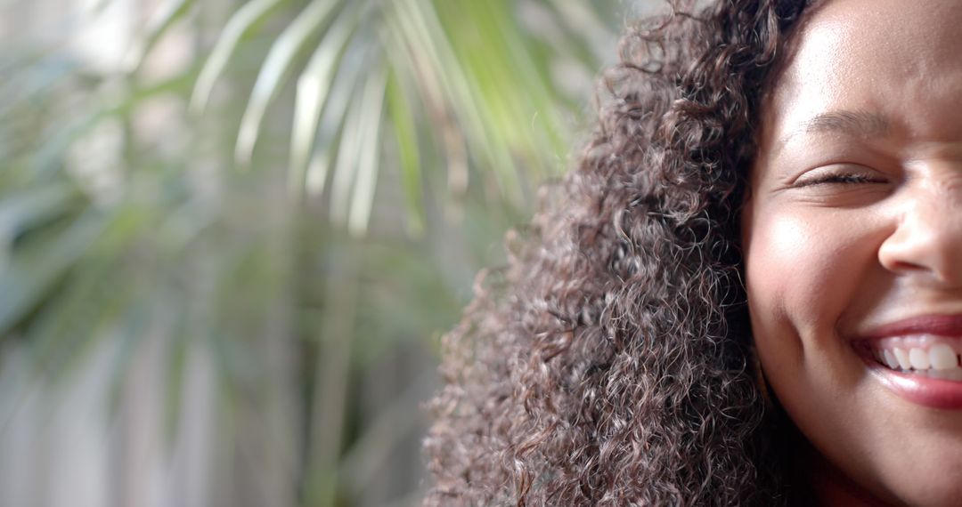 Close-up of Woman Smiling with Curly Hair in Natural Light - Free Images, Stock Photos and Pictures on Pikwizard.com