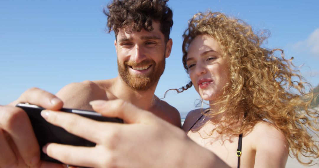 Couple Taking Selfie on Sunny Beach - Free Images, Stock Photos and Pictures on Pikwizard.com