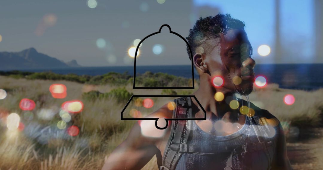 Standing fit hiker on coastal dunes with bell notification overlay and bokeh lights