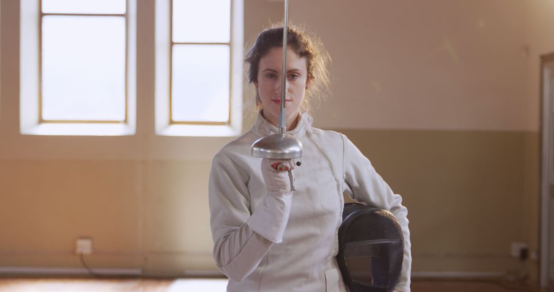 Female Fencer Holding Sword in Training Center - Free Images, Stock Photos and Pictures on Pikwizard.com