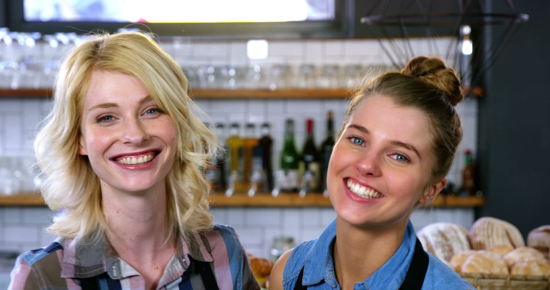 Two Happy Women Smiling in a Cozy Cafe - Free Images, Stock Photos and Pictures on Pikwizard.com