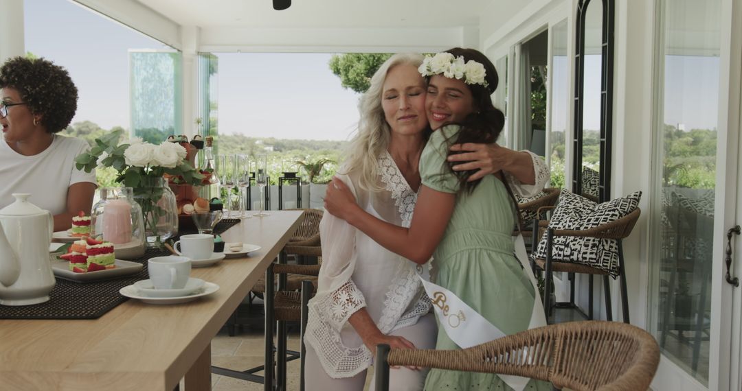Elderly Woman Hugging Young Woman at Joyful Bridal Shower