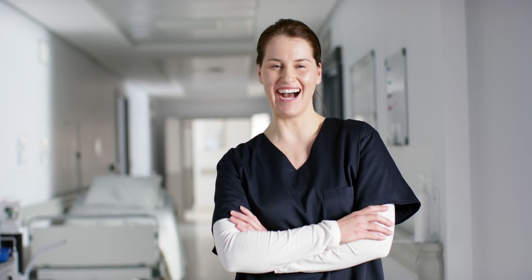 Confident Nurse Wearing Scrubs Standing in Hospital Hallway - Free Images, Stock Photos and Pictures on Pikwizard.com