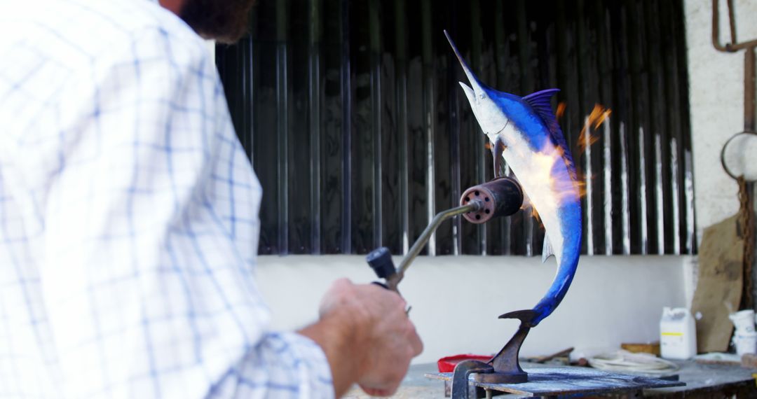 Artist Soldering Metal Swordfish Sculpture - Free Images, Stock Photos and Pictures on Pikwizard.com